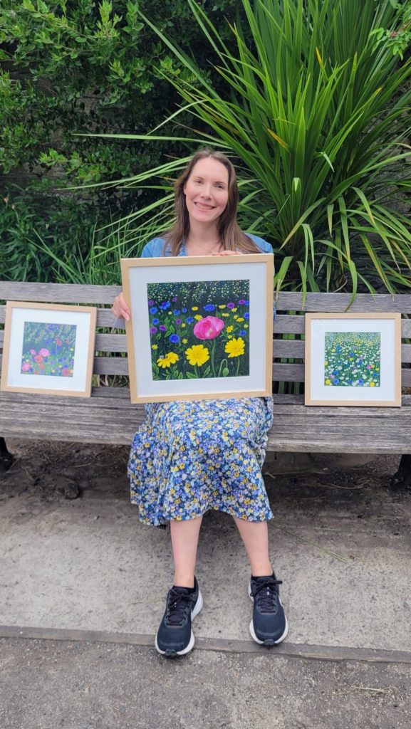 Kate Broadhurst Rodd, holding her own artwork.
